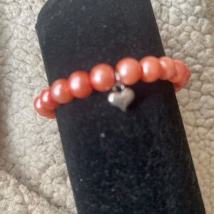 Pink bracelet with heart charm